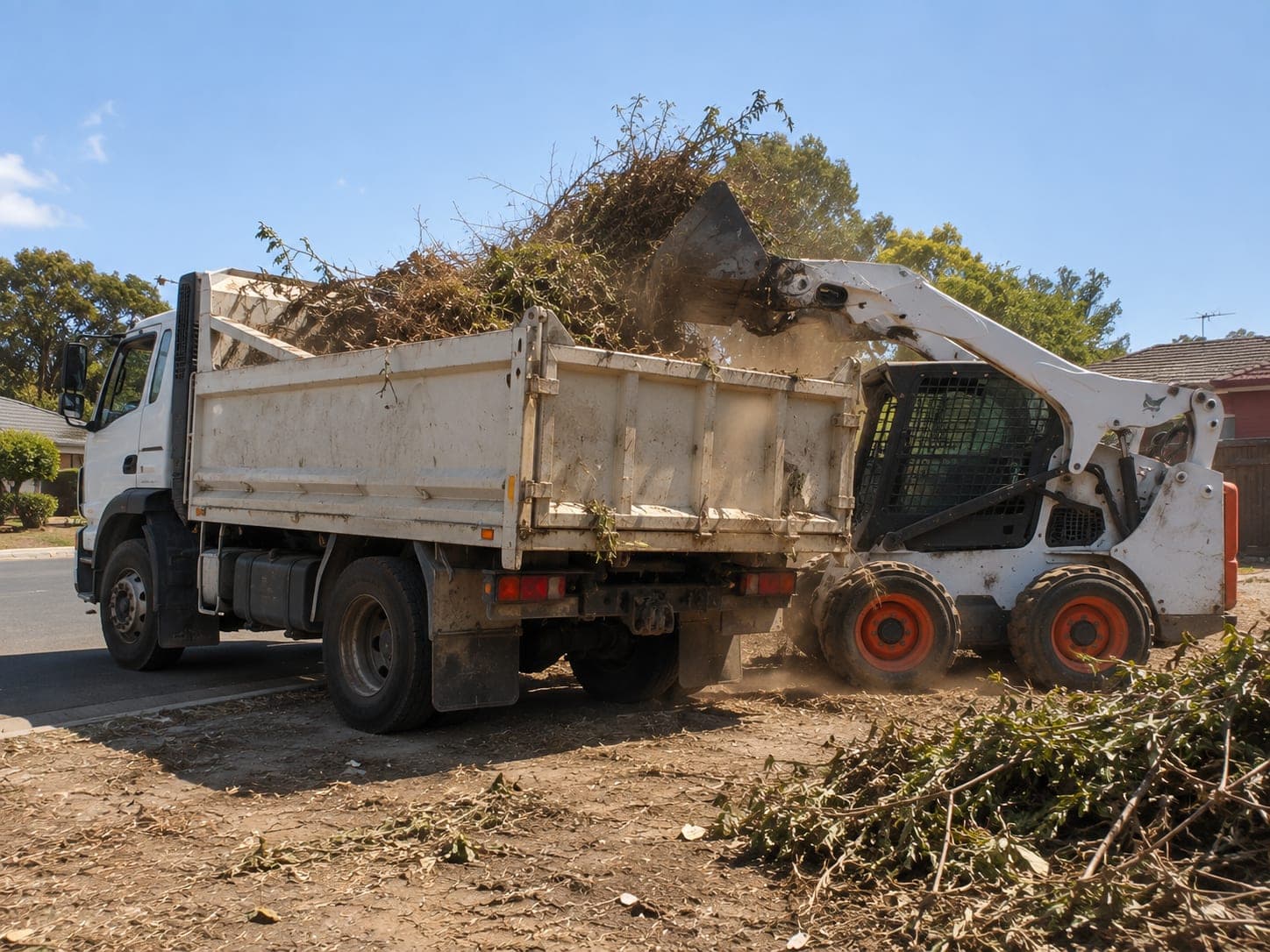 Truck being loaded with cleared debris on a residential block